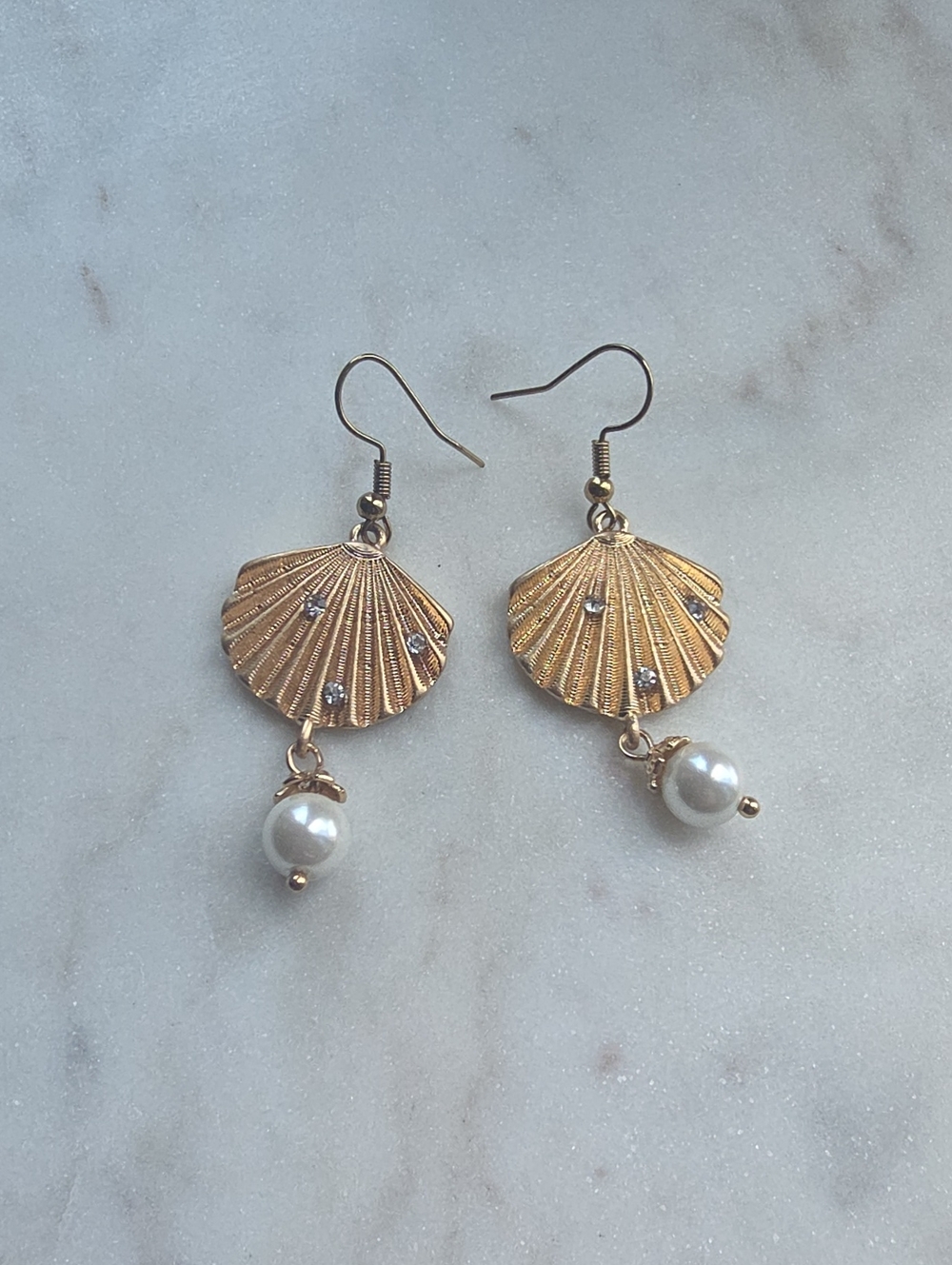 Gold-tone scallop shells with embedded rhinestone studs and a faux pearl dangle